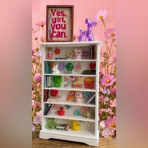 White Miniature Display Shelf with Colorful Trinkets
